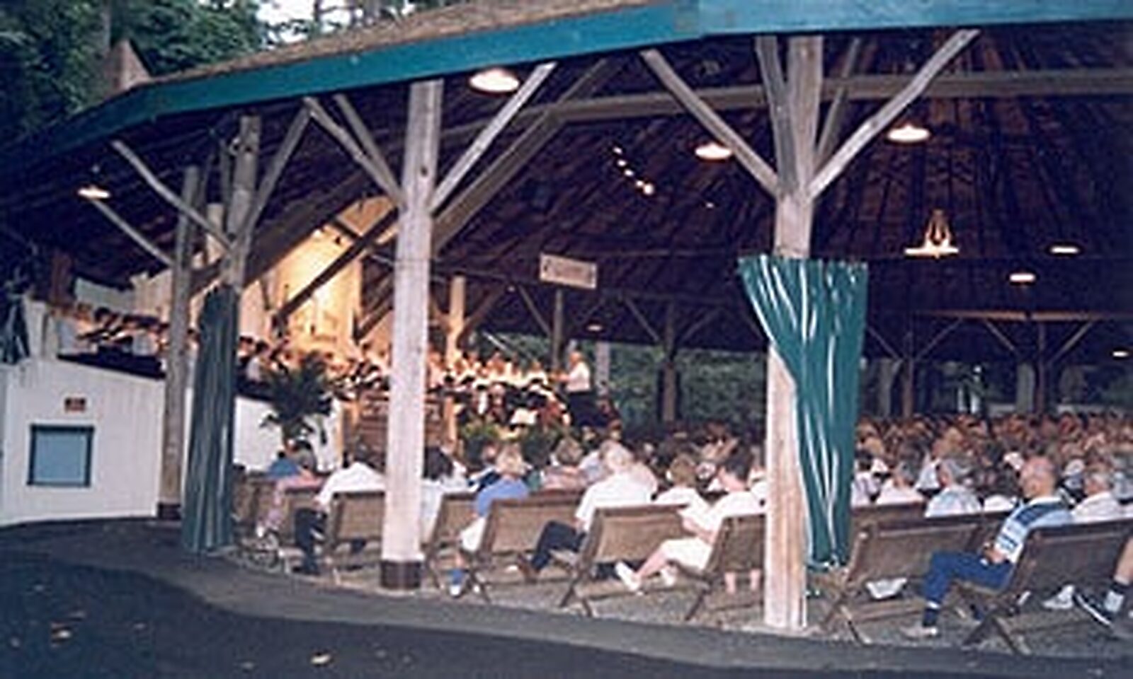 Vintage photograph of an audience seated in lawn chairs at a Tabernacle concert